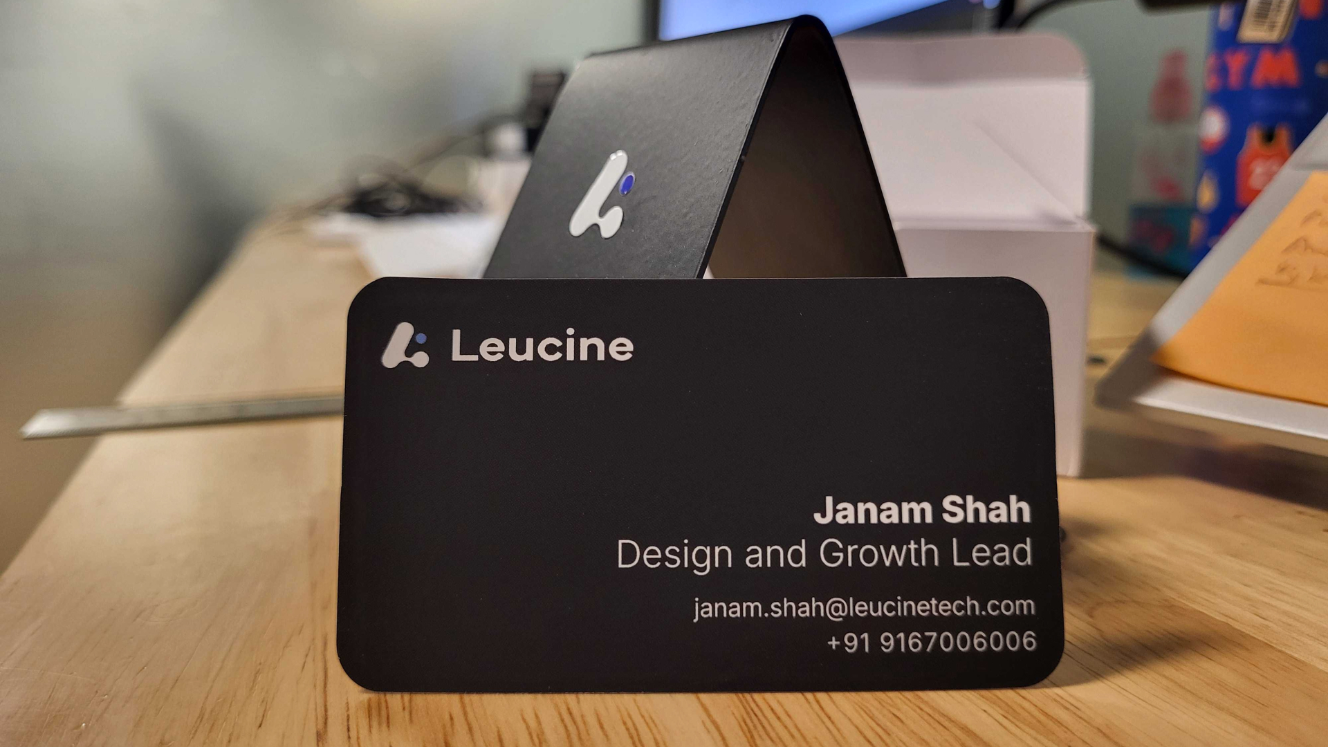Janam Shah business card — black matte with embossed wordmark, Design and Growth Lead